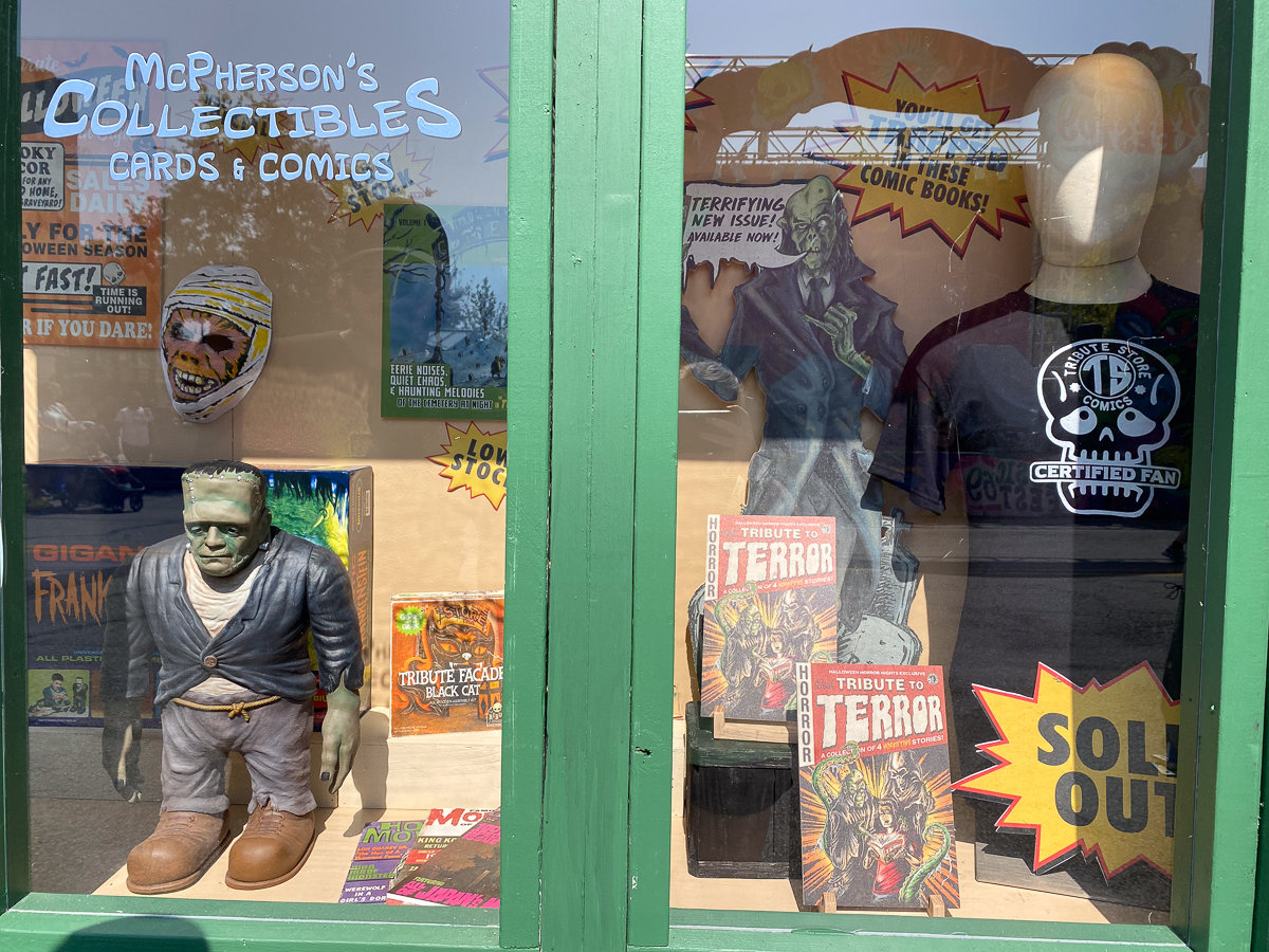 window into the store with horror figurines and other items